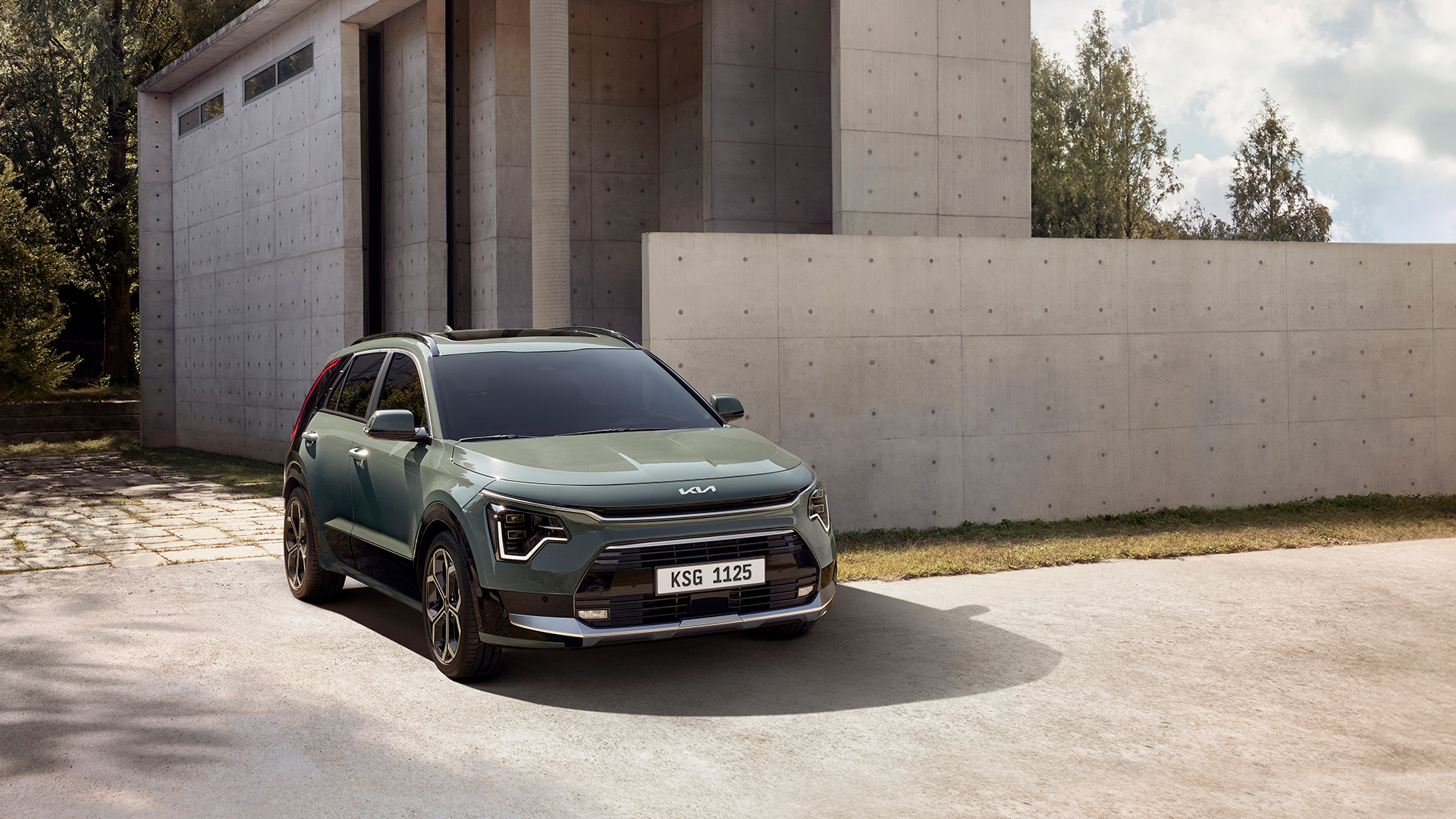 Front side view of Kia Niro EV parked in front of the building