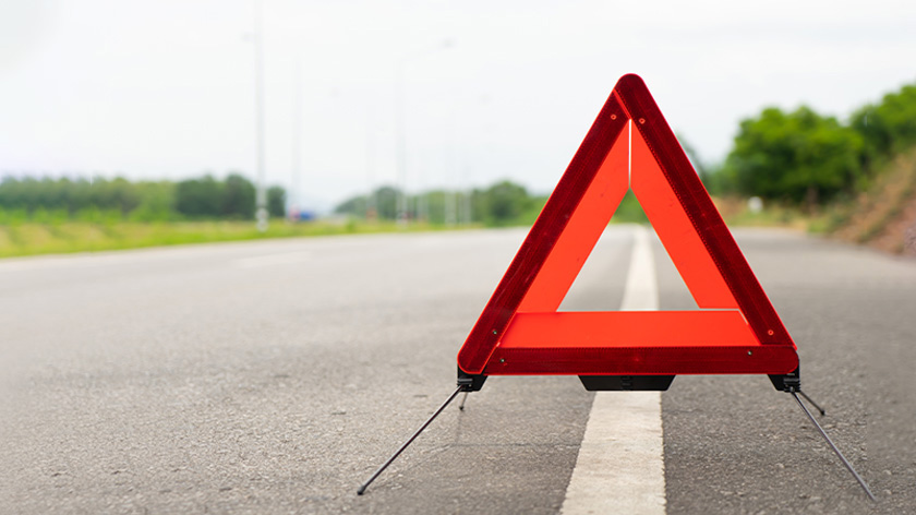 Close-up of emergency warning triangle sign on the road